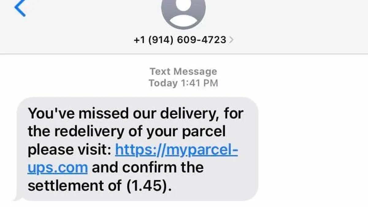 Person examining a UPS scam text message on a smartphone screen