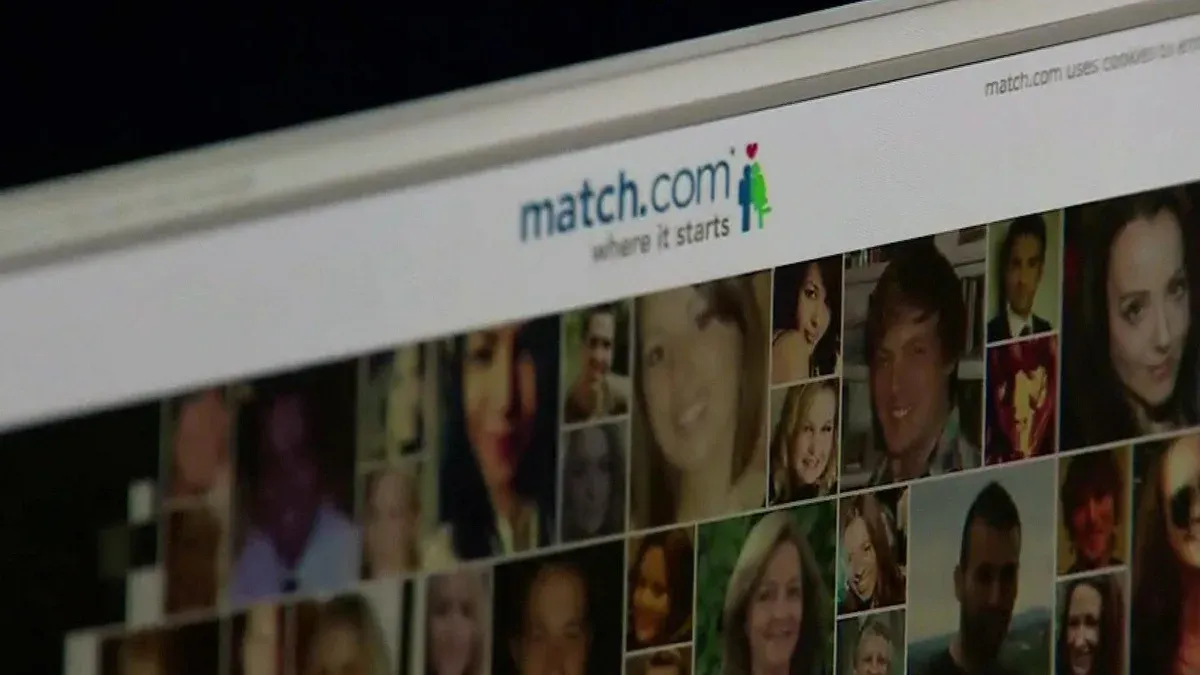 User recovering a hacked Match.com account on a laptop with security alert visible