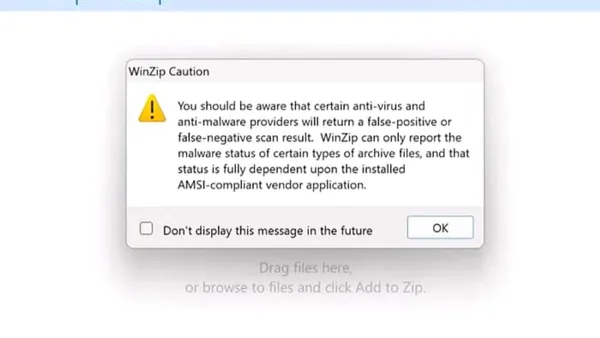 Person viewing a laptop screen with a warning about virus risk from a ZIP file
