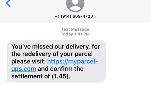 Person examining a UPS scam text message on a smartphone screen