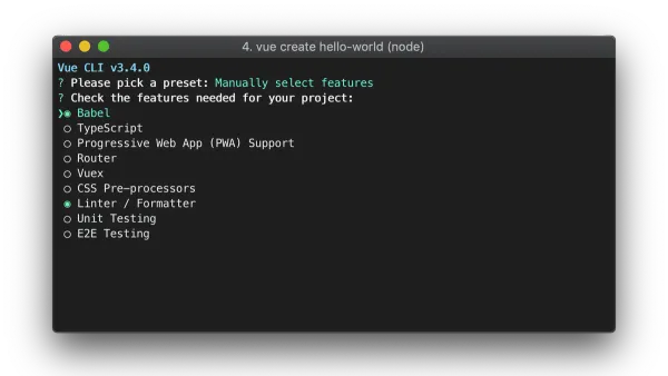 Developer installing Vue CLI on Mac laptop showing terminal commands
